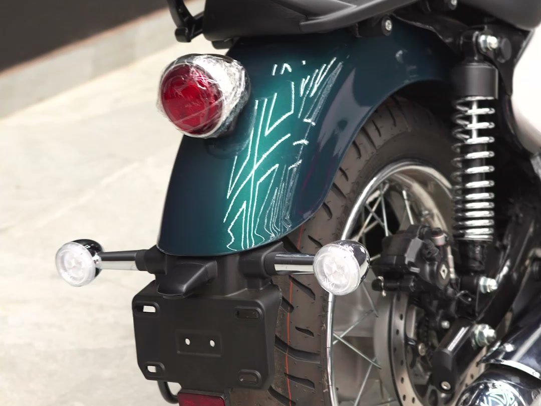 Clear film being laid over the rear mudguard of a Royal Enfield Meteor 350.