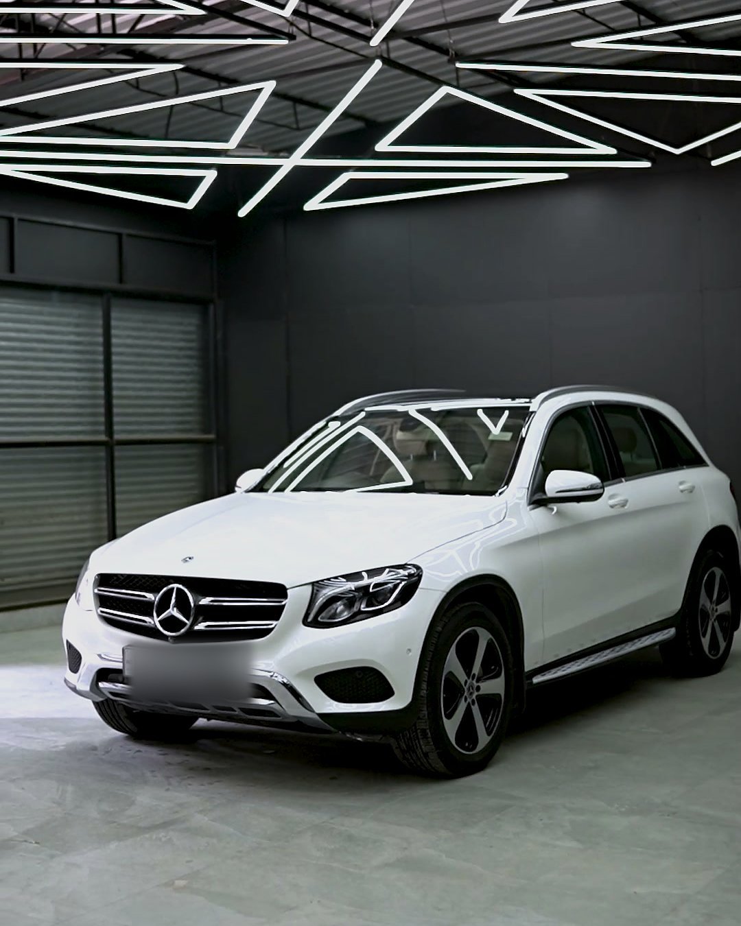 White Mercedes-Benz GLC under the studio grid.